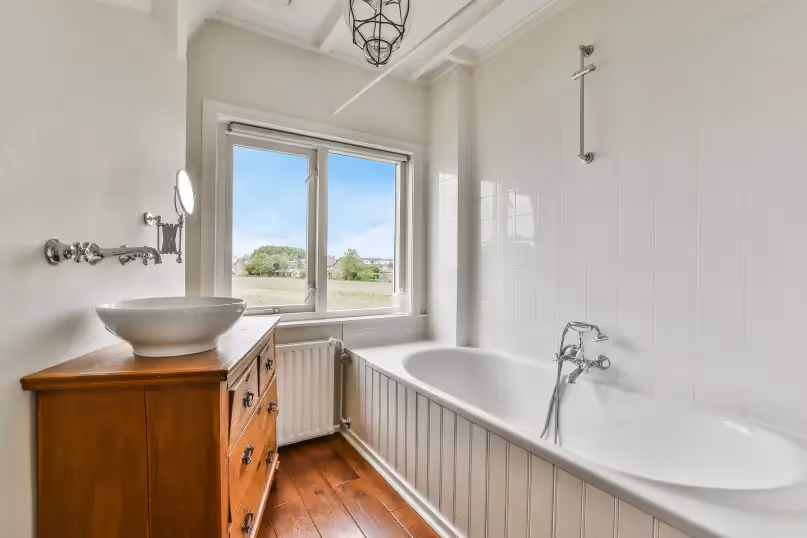 a white modern farmhouse bathroom with shiplap bathtub