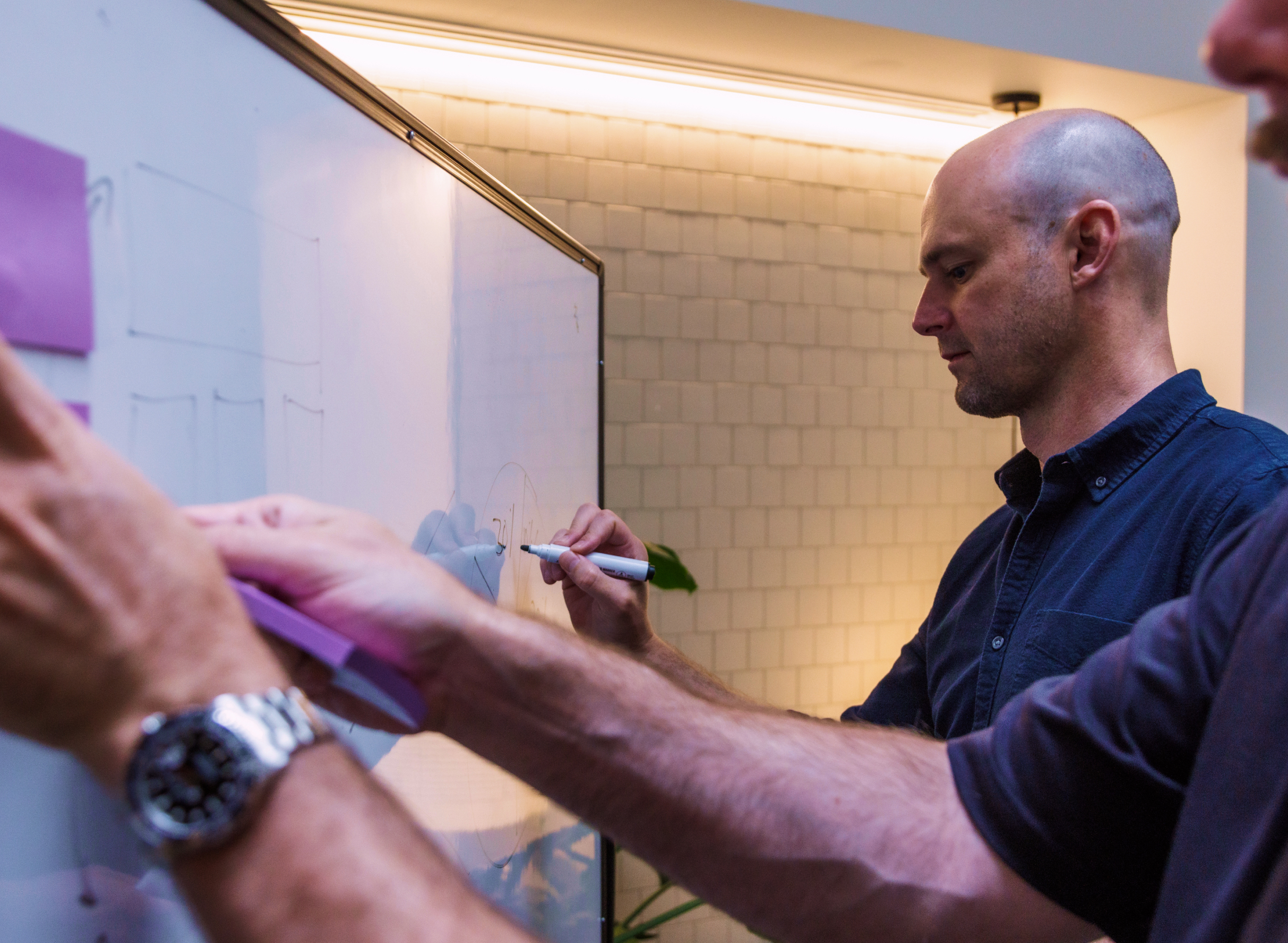 Design team collaborating on UX wireframes and UI concepts during a product design workshop