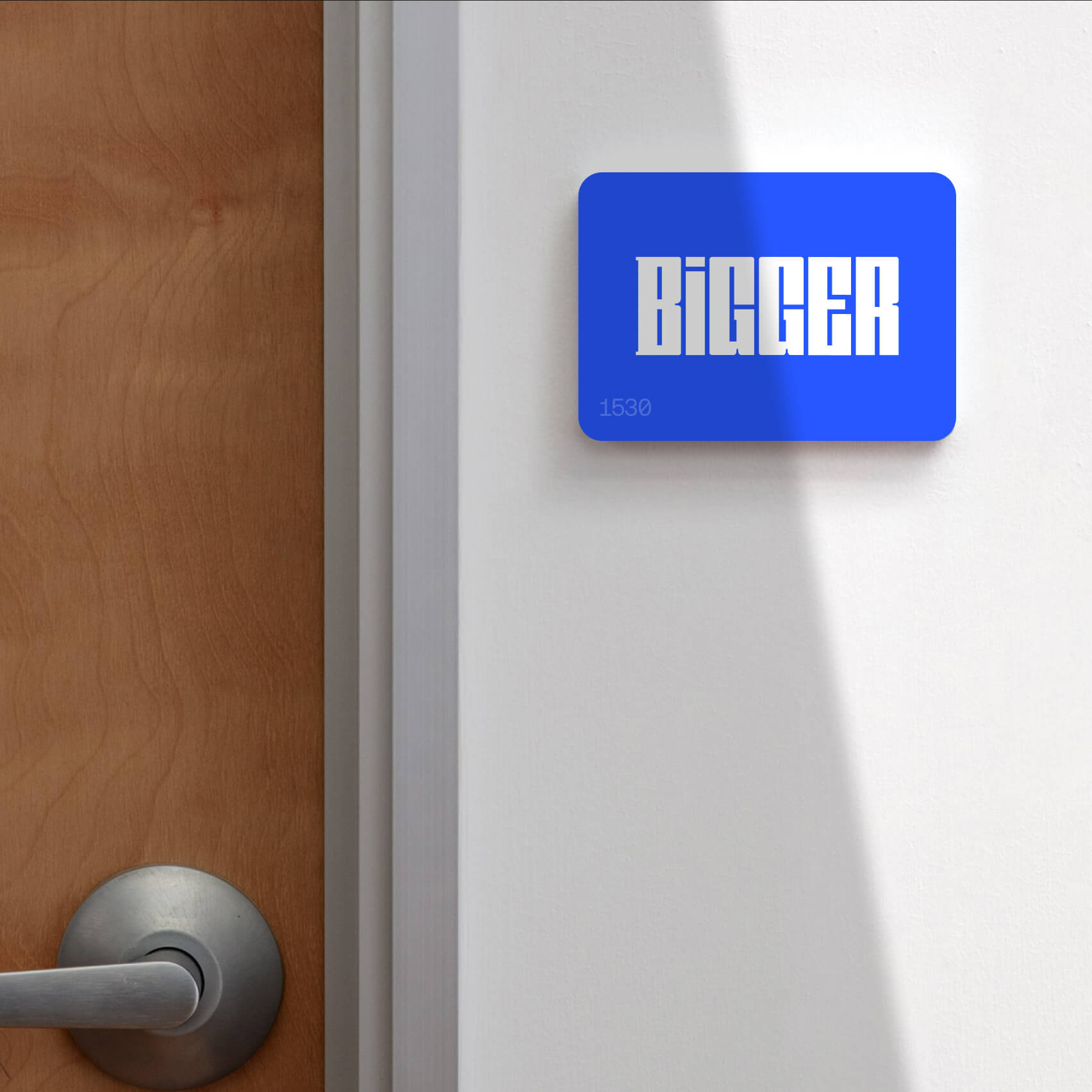 Bigger office signage showing the bold wordmark applied large across a feature wall