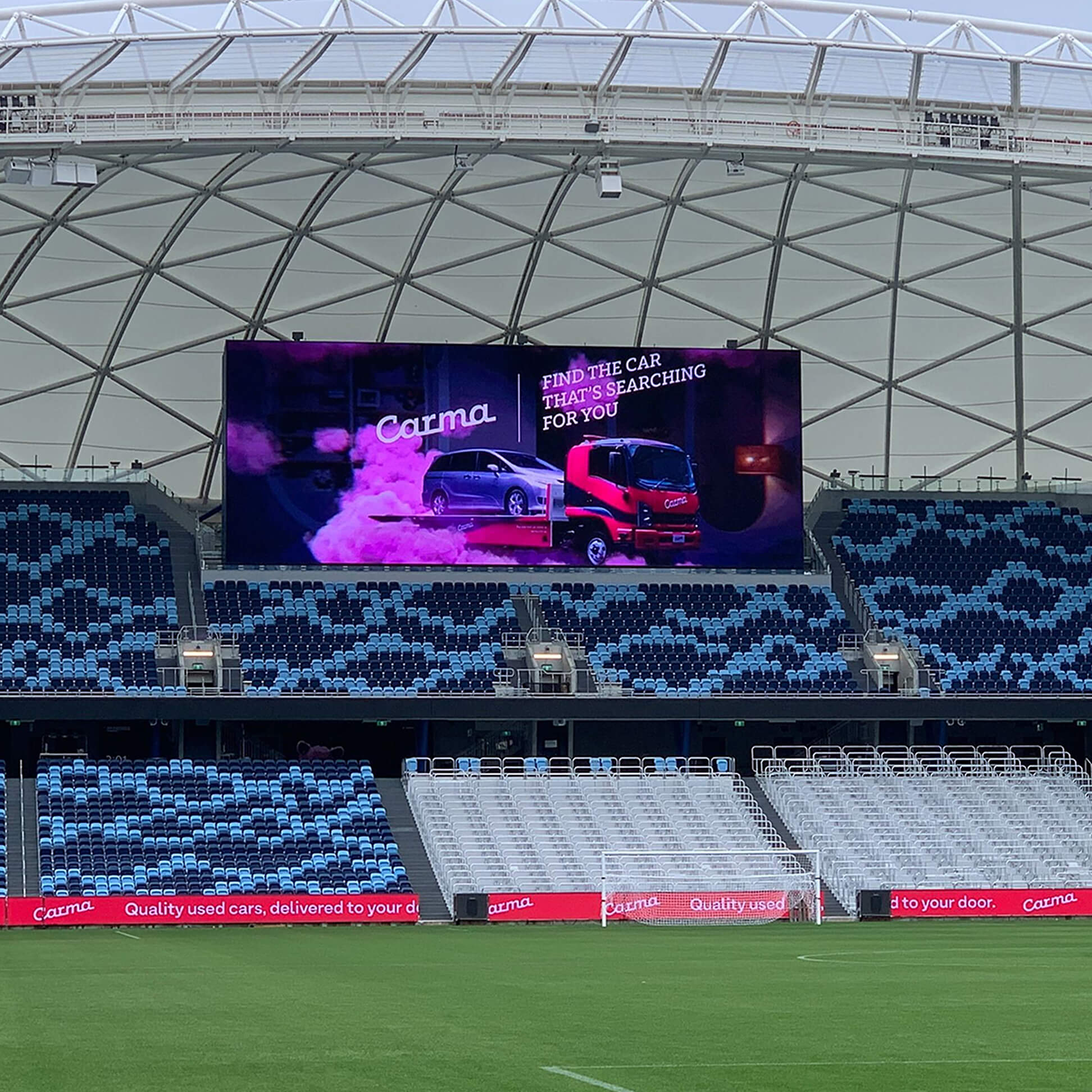 Carma stadium sponsorship signage showing the brand applied during a sporting event