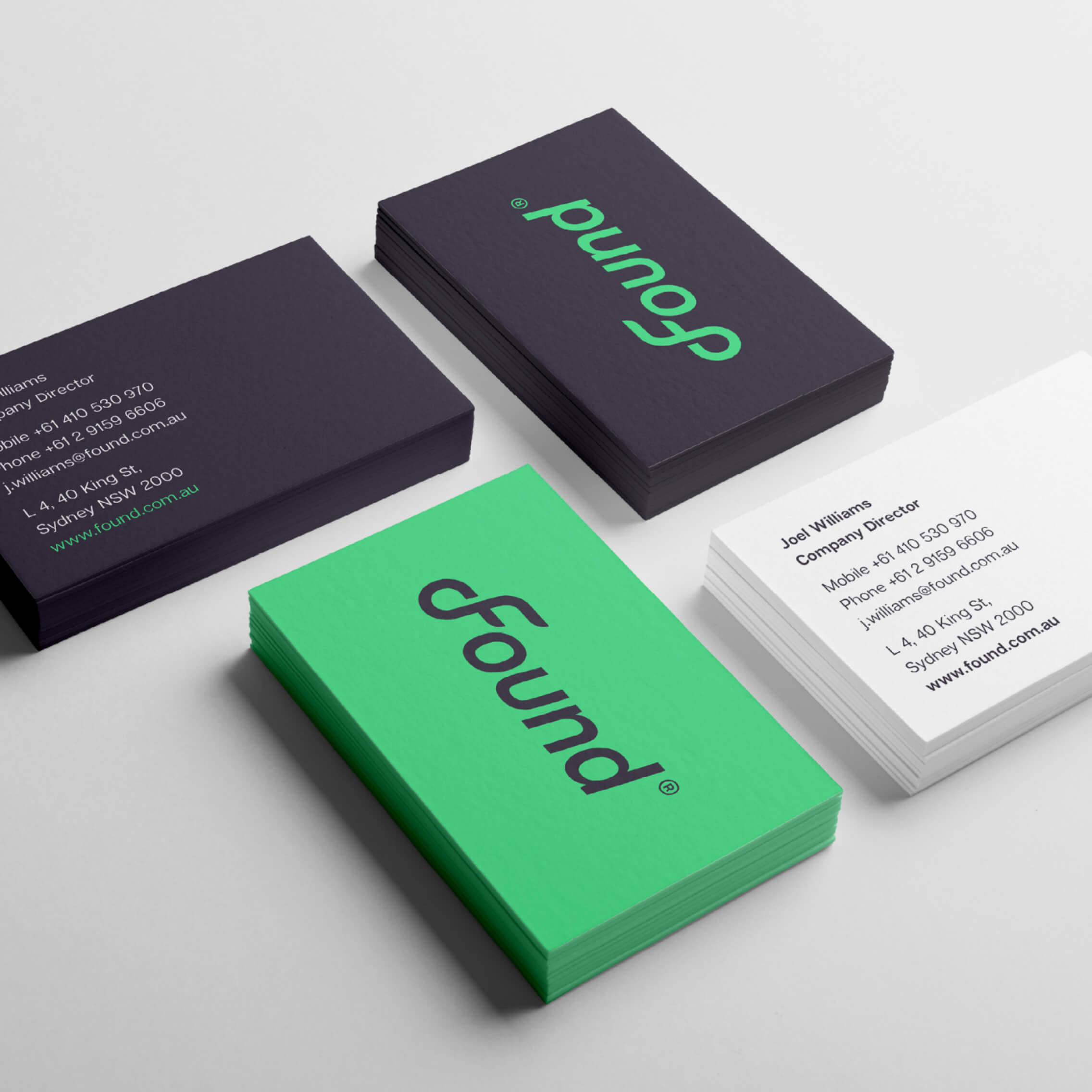 Found business card in the brand electric-green palette with the logo centred