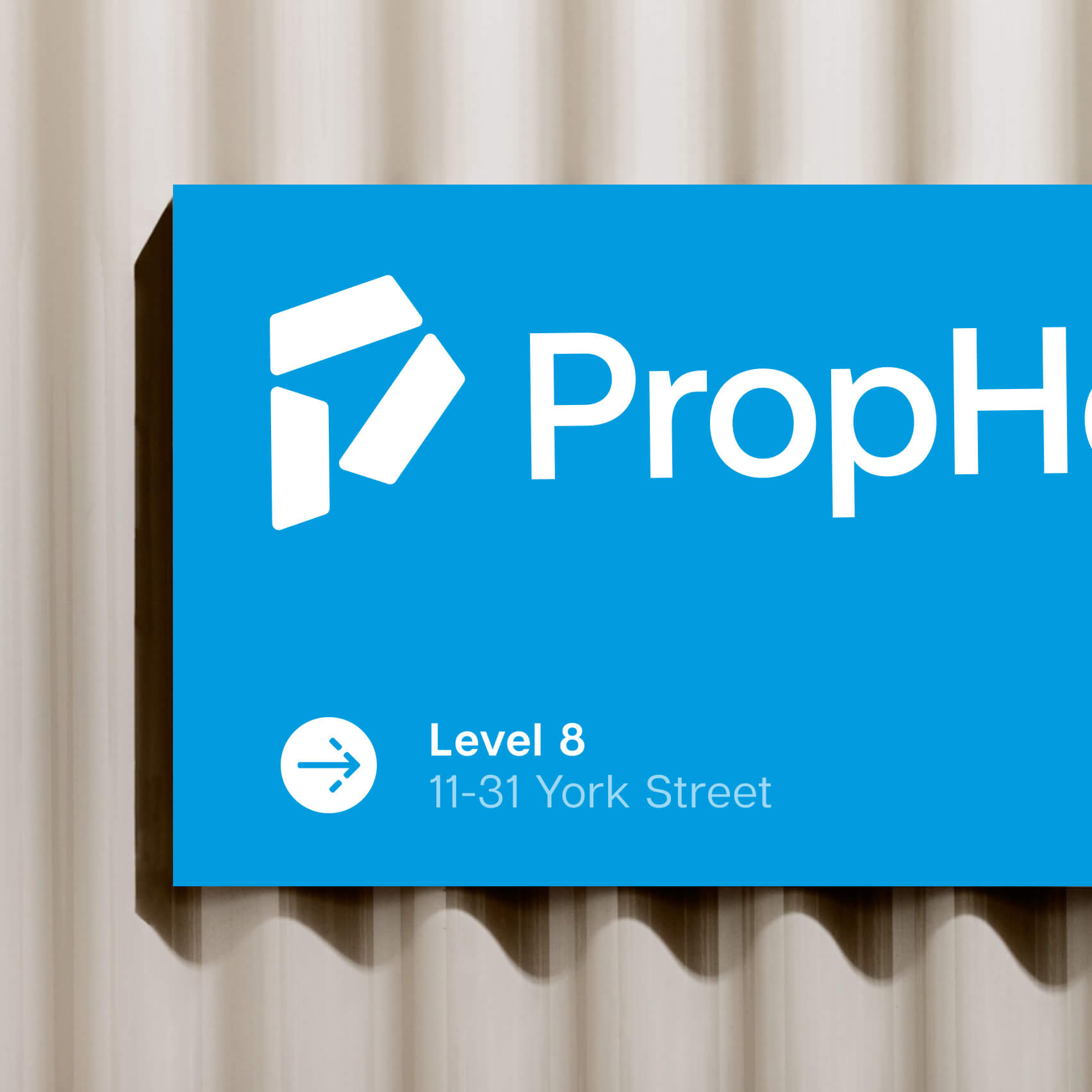 PropHero office sign featuring the P logomark with upward-pointing negative-space arrow
