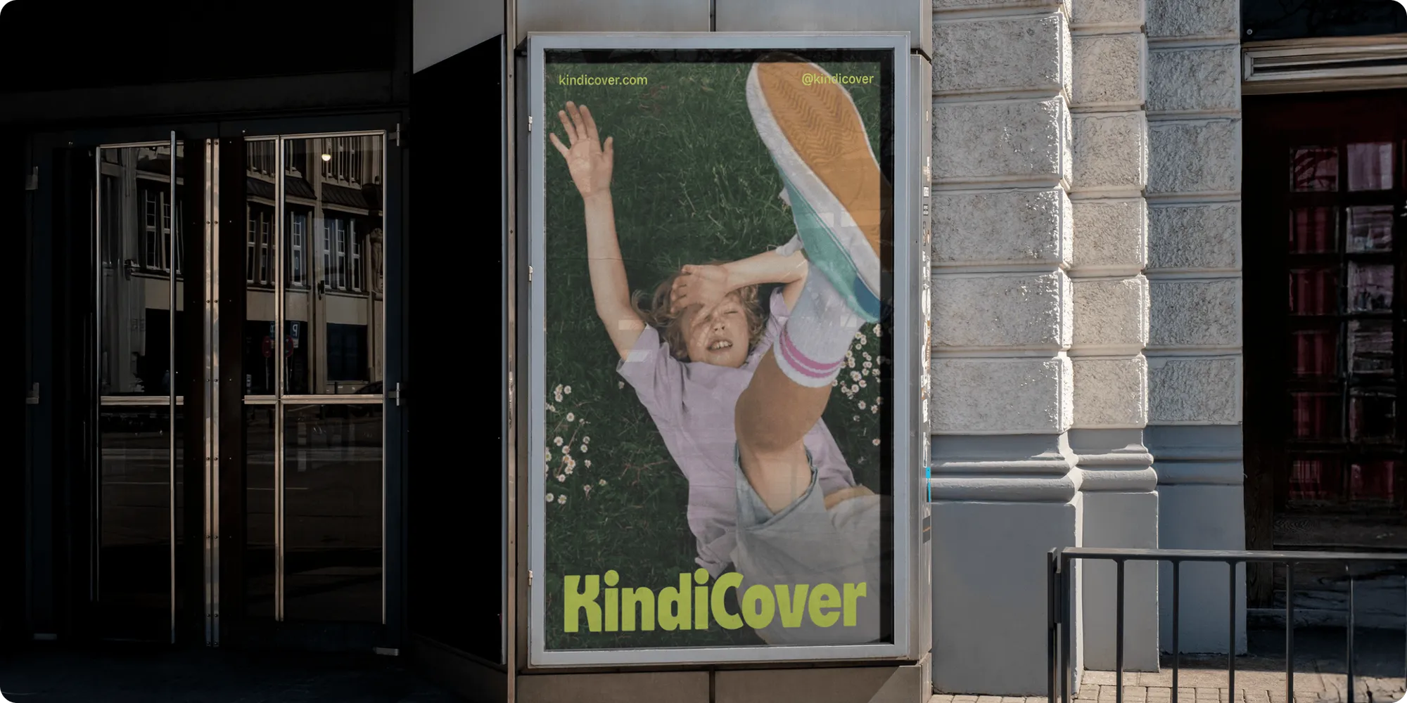 KindiCover K logomark inspired by a puzzle-board toy, shown large on a bright background
