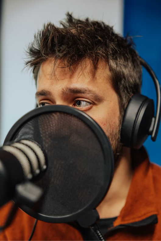 En bild som visar Hörlurar, Människoansikte, Ljudutrustning, personAI-genererat innehåll kan vara felaktigt.