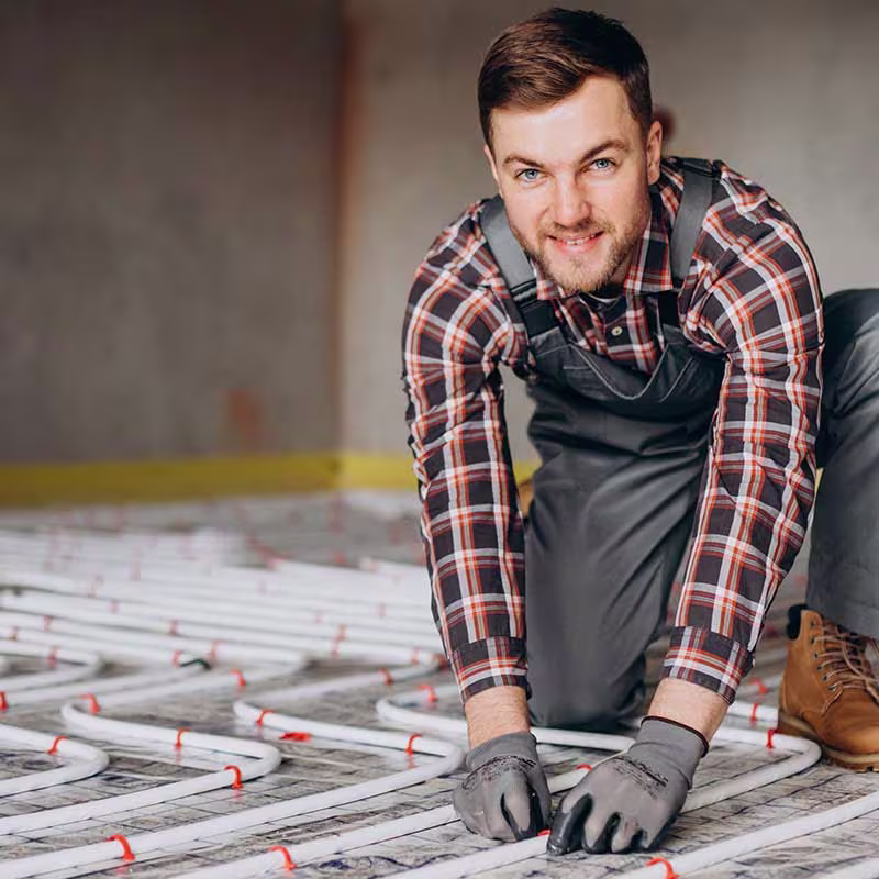builder installing underfloor heating
