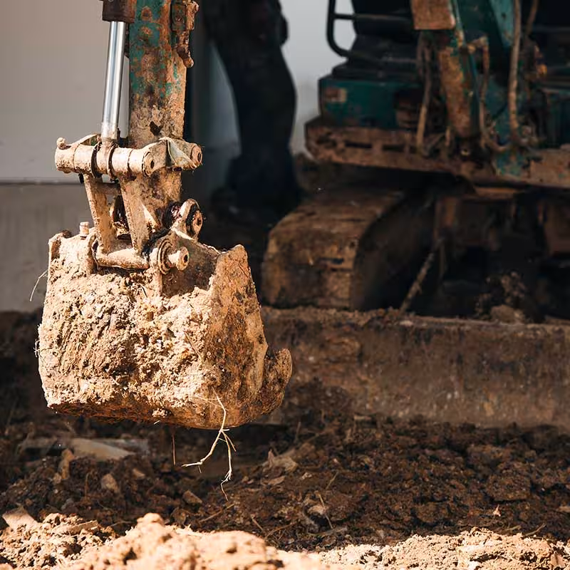 digger digging a hole for ground analysis
