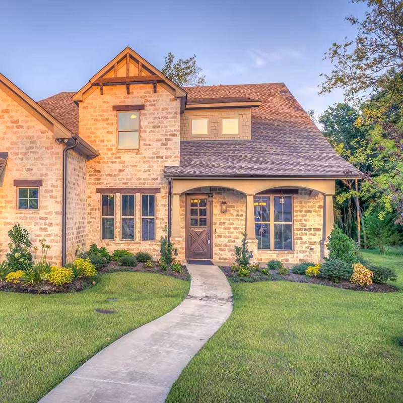 large brick house with big front yard