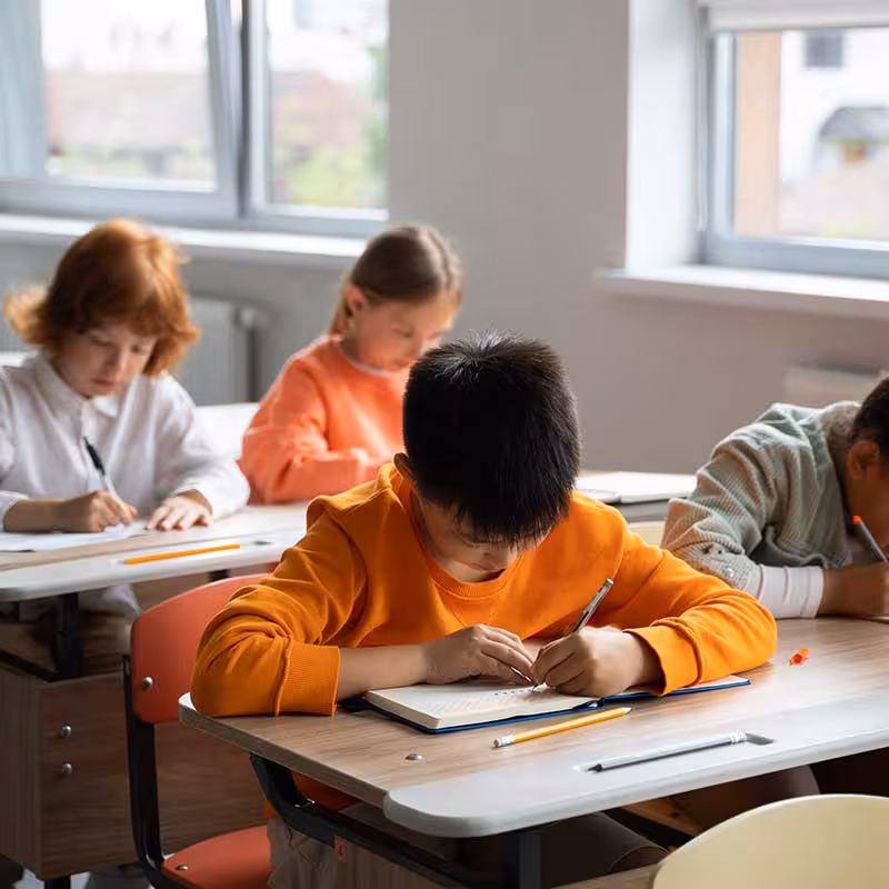 children taking notes at school