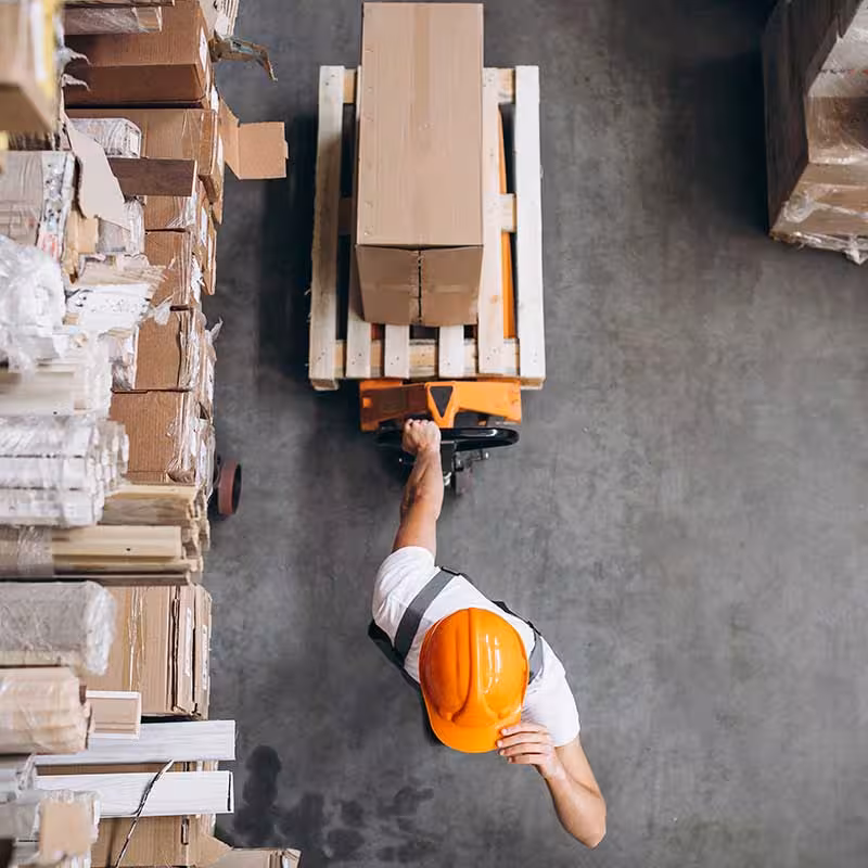 warehouse worker dragging a trolley, top view