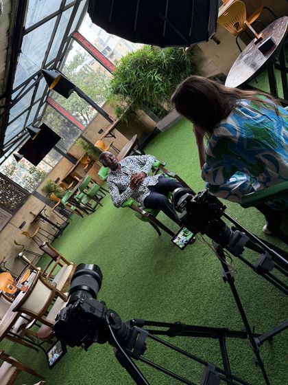 A Happy Productions two-camera interview setup with a bounce reflector on a rooftop