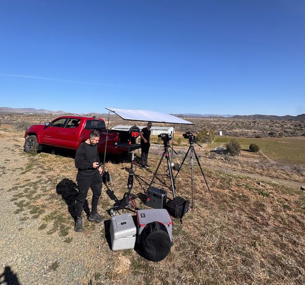 A Happy Productions crew rigging overhead diffusion on a remote ranch hilltop