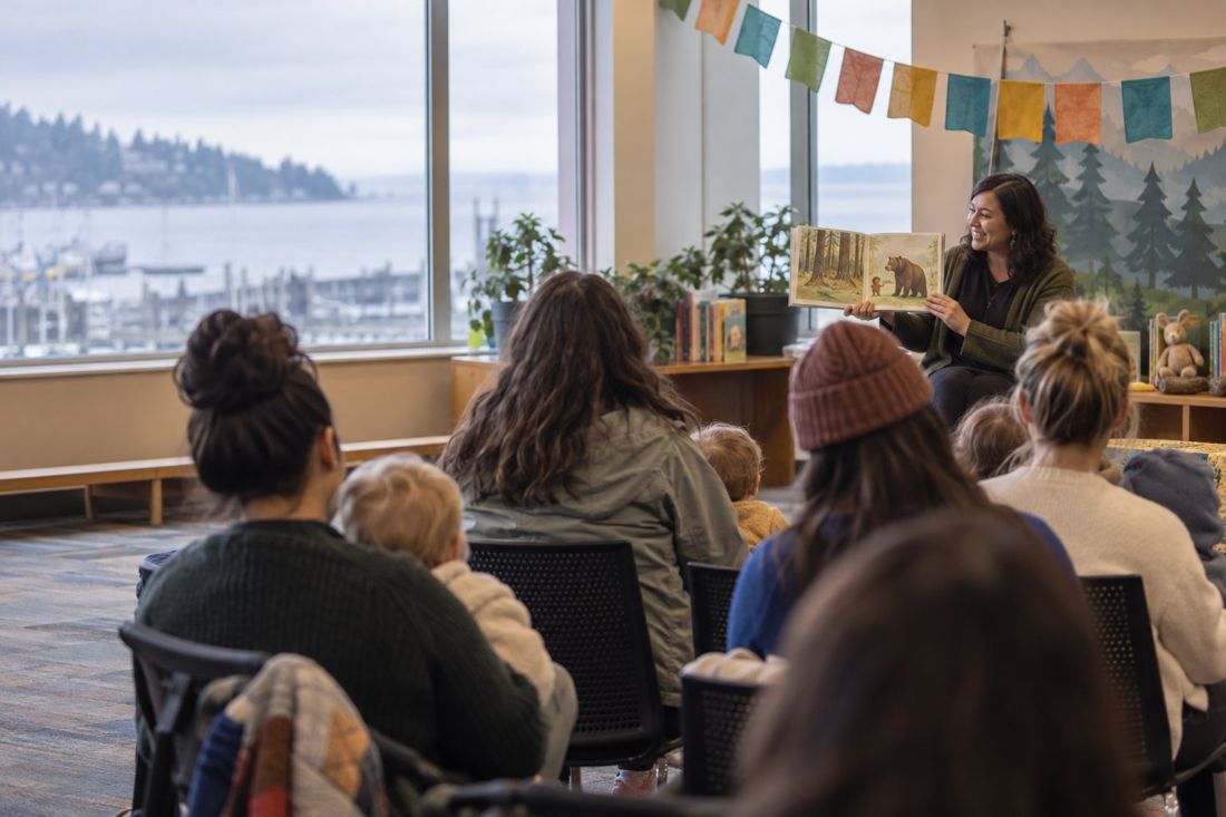Concept frame: a community reading event filmed from behind the audience