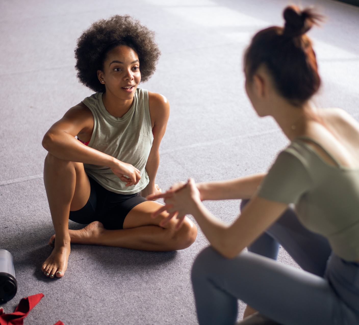 Two women talking and smiling after a training session 