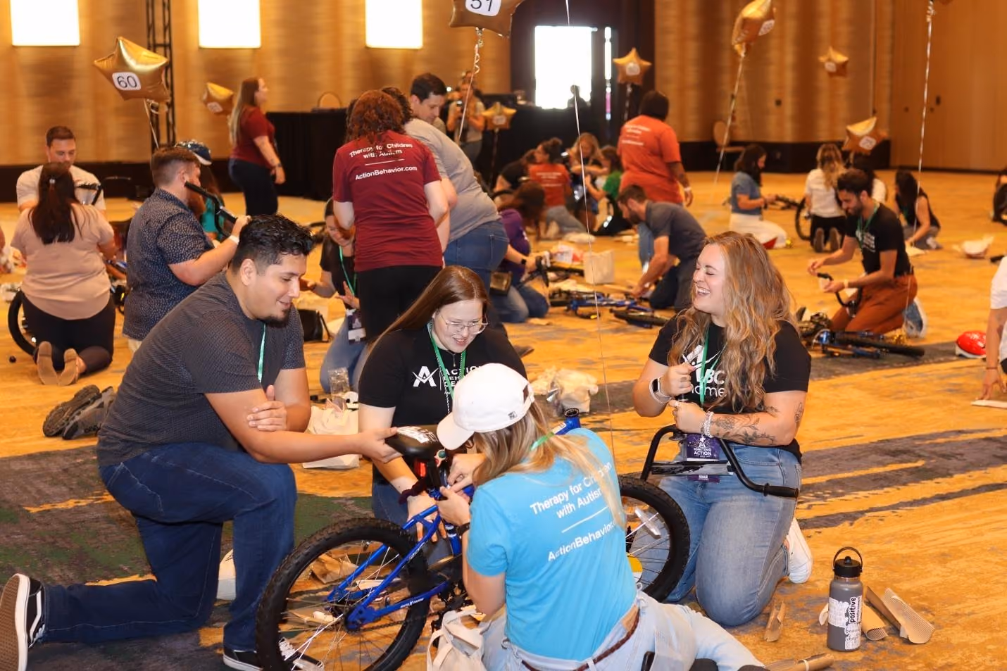 A group of people working on bikesDescription automatically generated