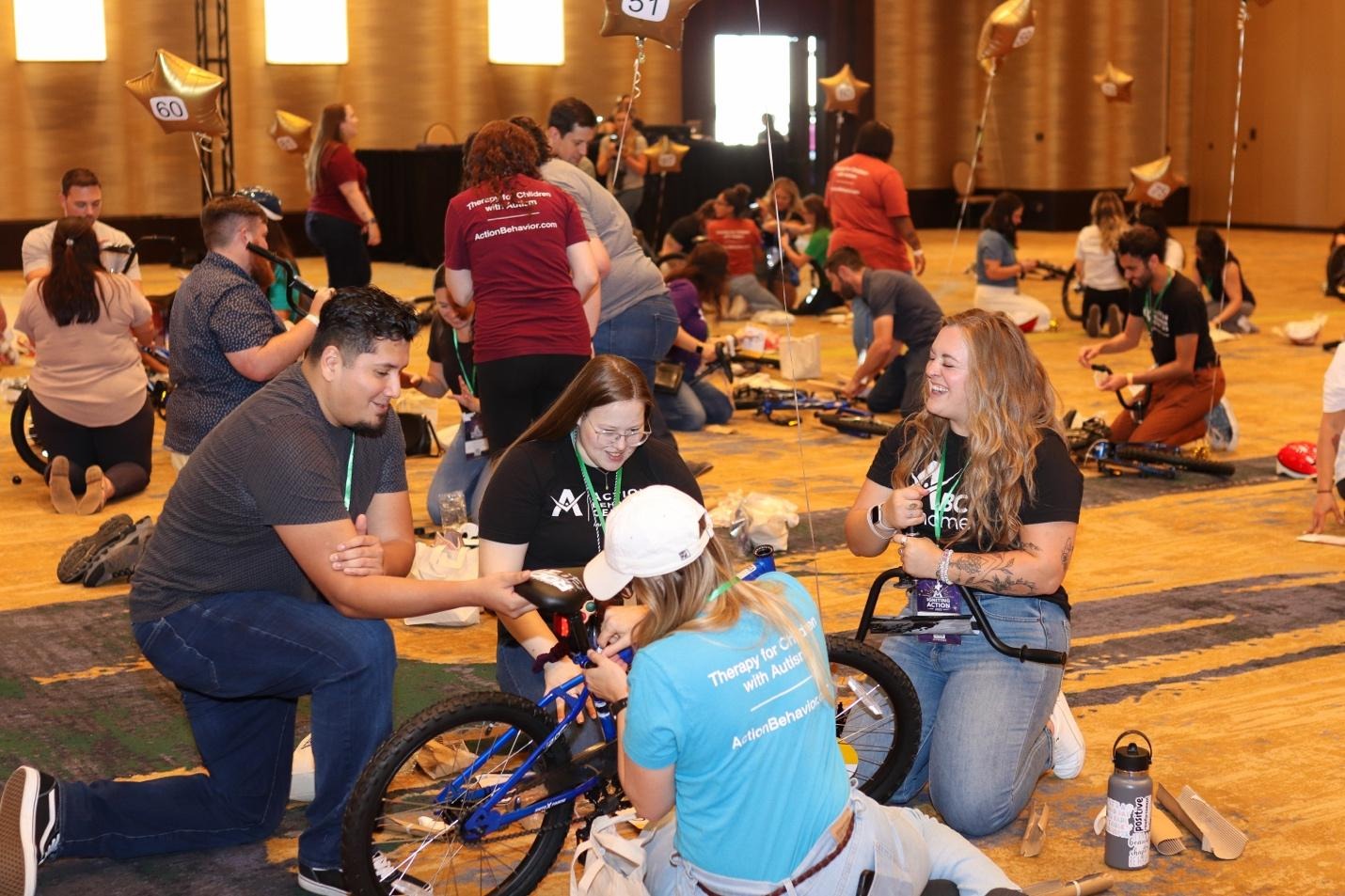 A group of people working on bikesDescription automatically generated