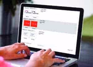 Hands typing on laptop