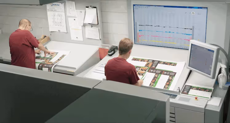 Proofreaders at Phoenix Litho manually examine press sheets for errors