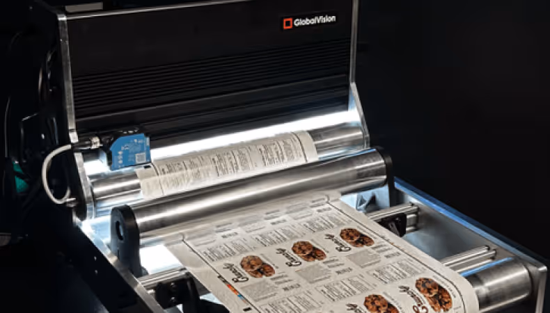 GlobalVision Verify inline inspecting a printed sheet with images of cookies and text on a black surface