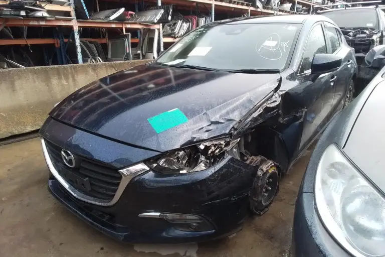 Wrecked Mazda sedan in Melbourne ready for junk car removal quote and cash for scrap vehicle service.