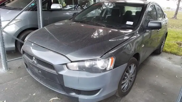 Used Mitsubishi Lancer being assessed, showing how vehicle condition and mileage affect car valuation and trade-in value.