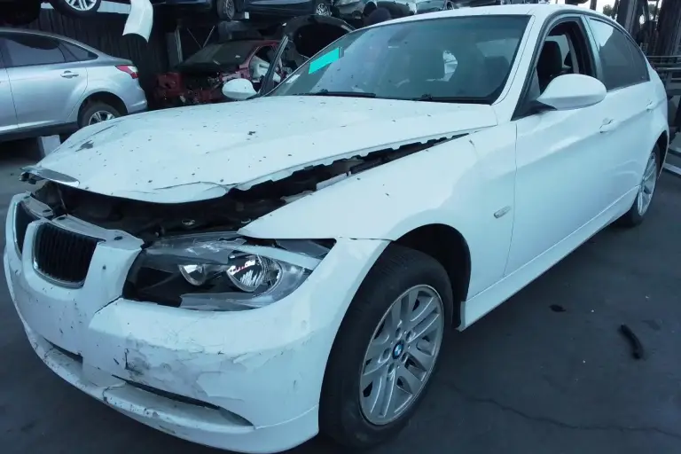 White BMW sedan with bonnet and bumper damage, an example of a repairable write-off car in Australia where insurance companies assess market value and repair costs.