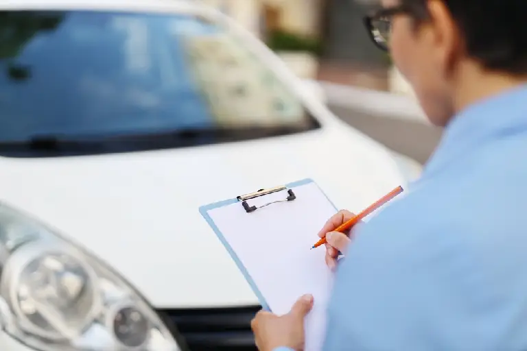 The car valuation expert fills in the back view form.