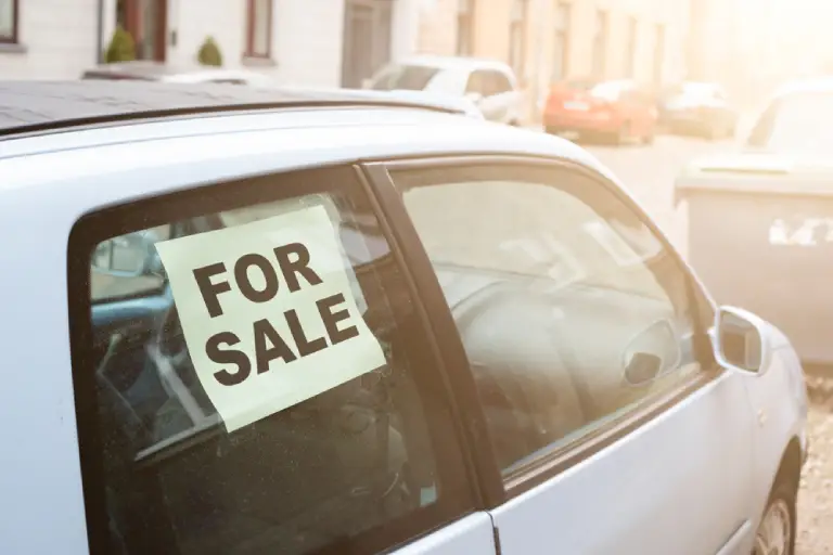 for sale. old dirty car on the street with inscription in the window