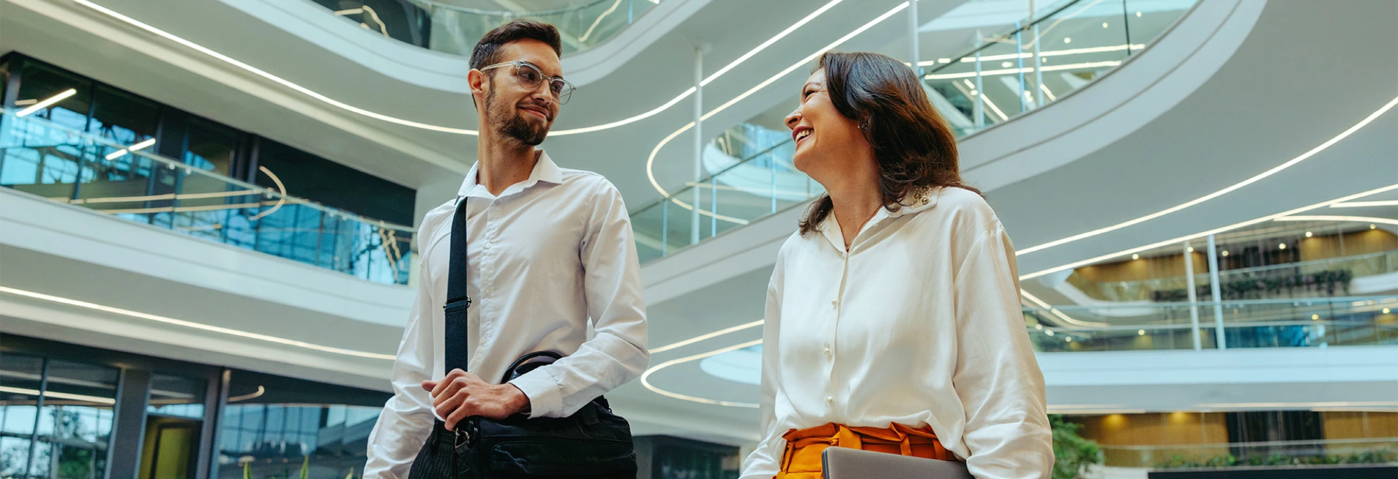 Two colleagues walking and smiling