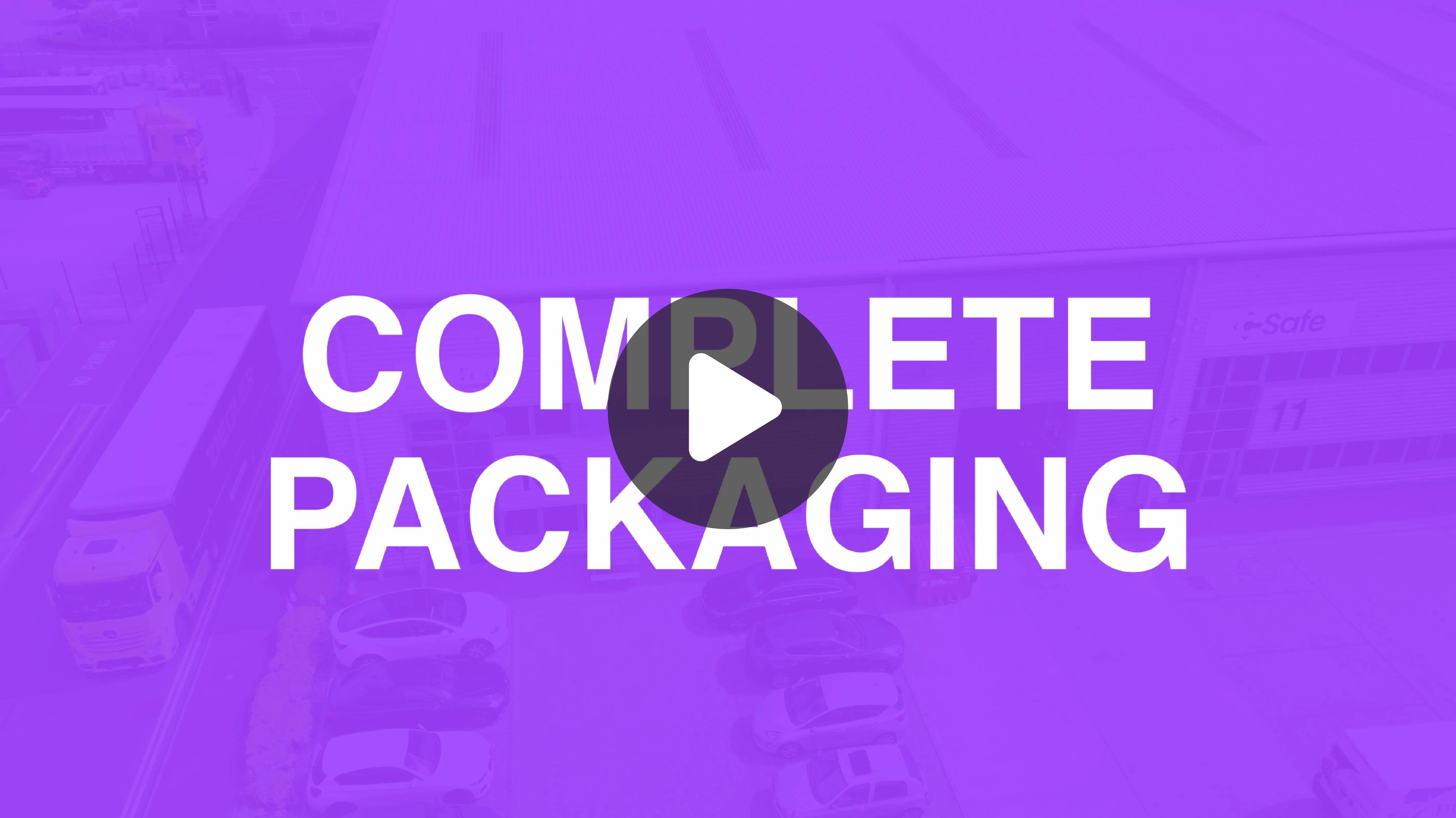 Aerial view of a warehouse with trucks and parked cars, overlaid with large white text 'COMPLETE PACKAGING' and a central play button icon.
