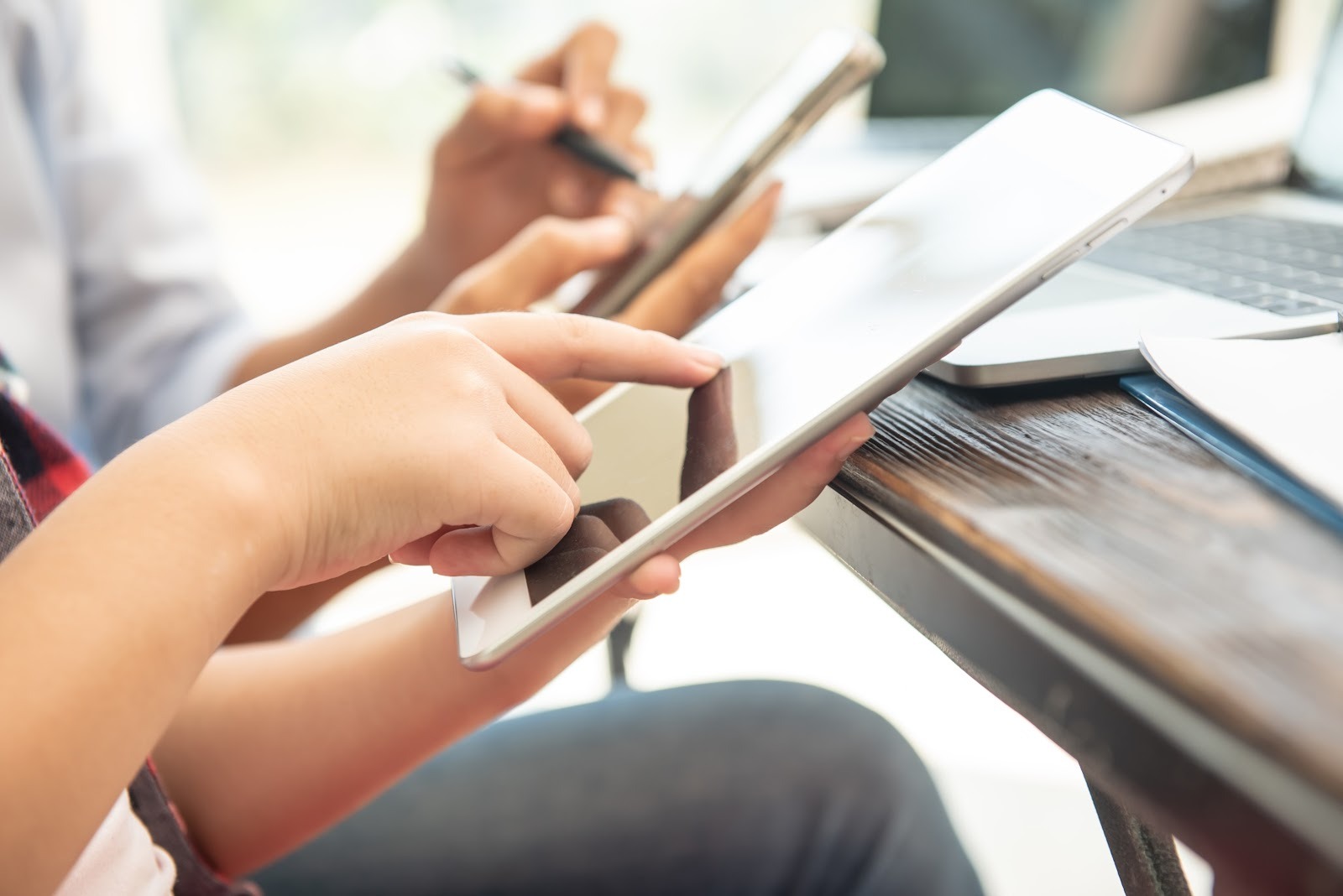 Two professionals pointing at tablets