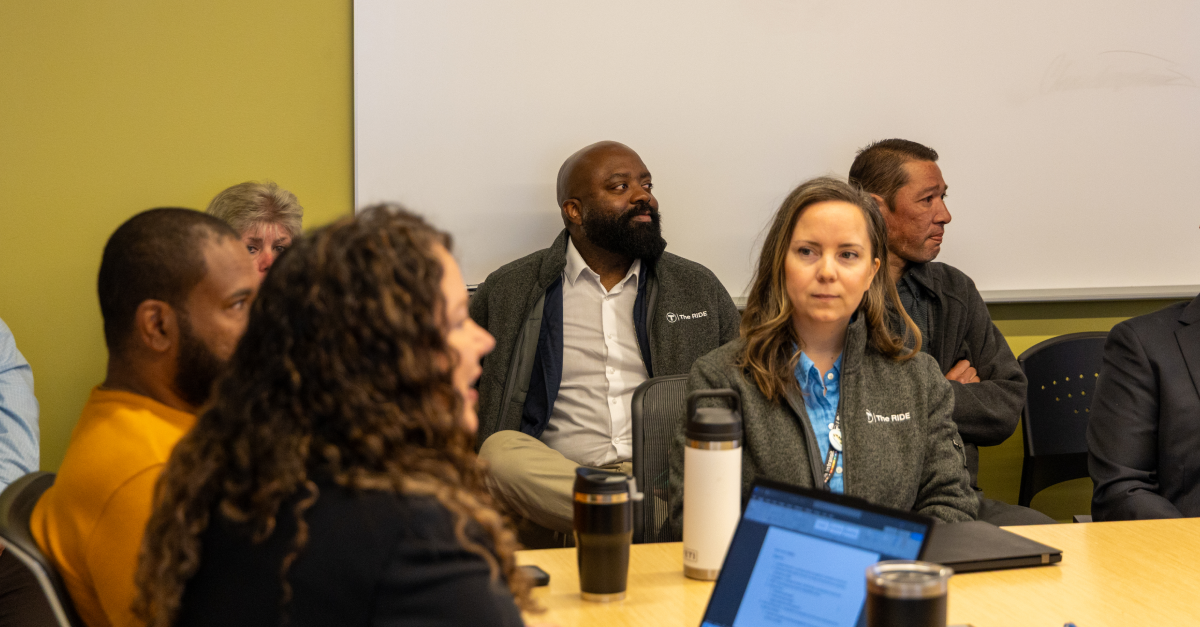 MBTA and Spare team members sit around a meeting table in discussion during The RIDE implementation planning session.