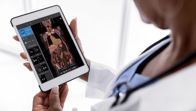 Doctor reviewing brain scan from tablet on radiology RIS software.