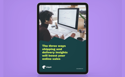 Person analysing data on a computer screen in an office environment, with charts and graphs displayed on the monitor.