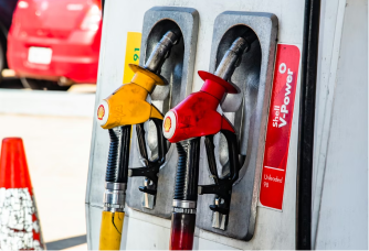 Close-up of a gas station pump showing fuel options and prices for diesel, regular unleaded, unleaded plus, and unleaded premium.
