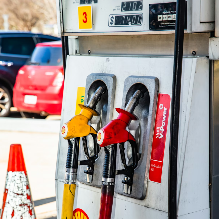 Close-up of a gas station pump showing fuel options and prices for diesel, regular unleaded, unleaded plus, and unleaded premium.