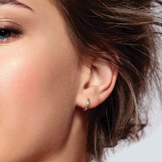 The side burns of a woman wearing jewellry