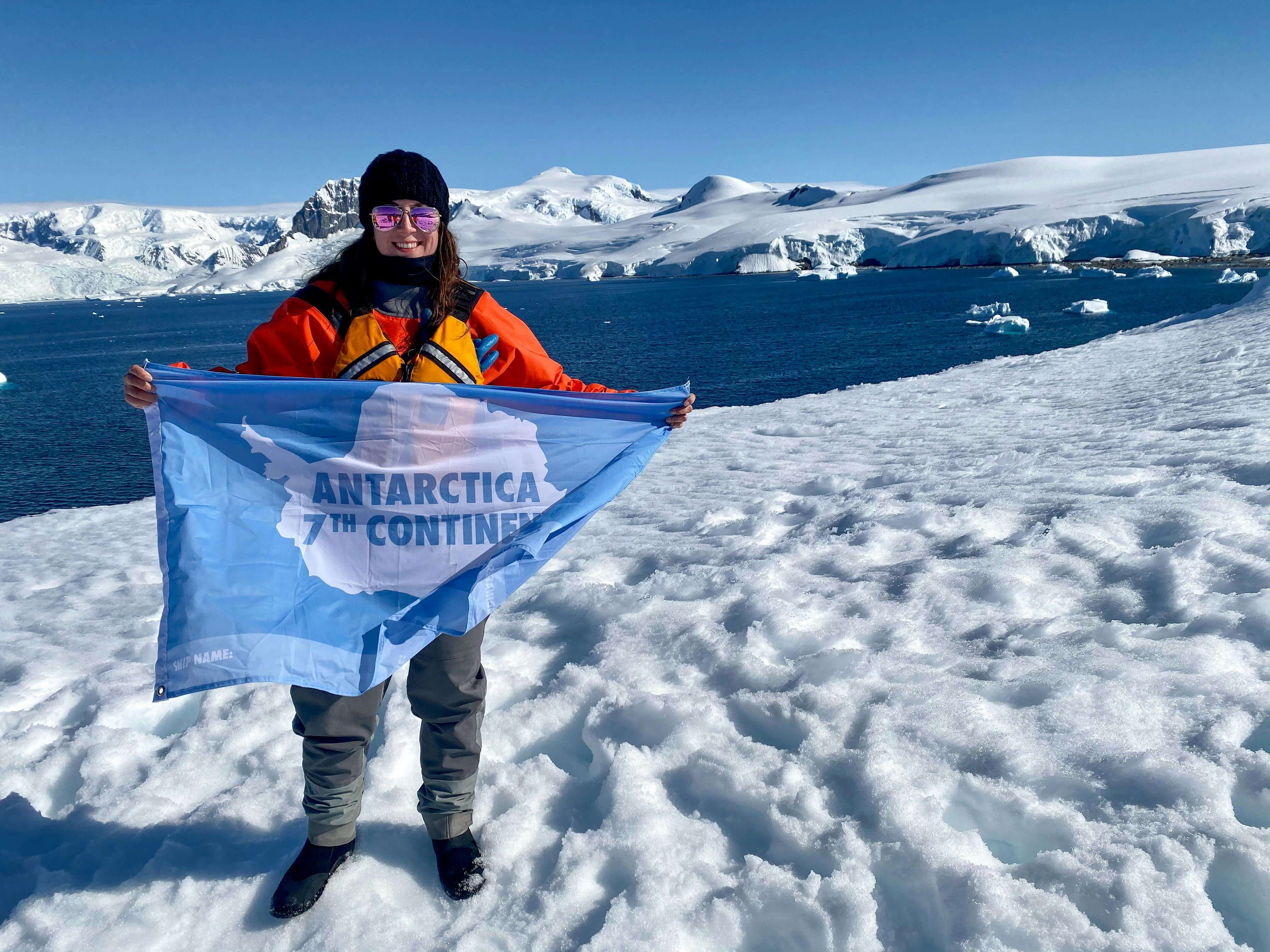 a lady holding a flag stating 7th Continent