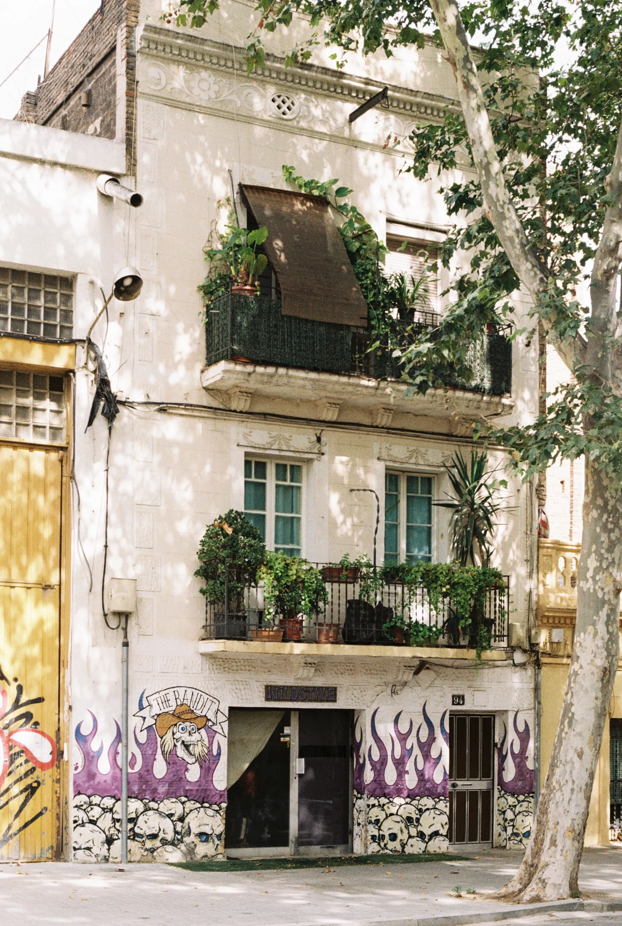 A multi-story building in Barcelona with balconies and plants