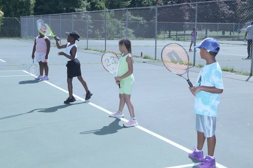 Youth Lined up on Tennis Court