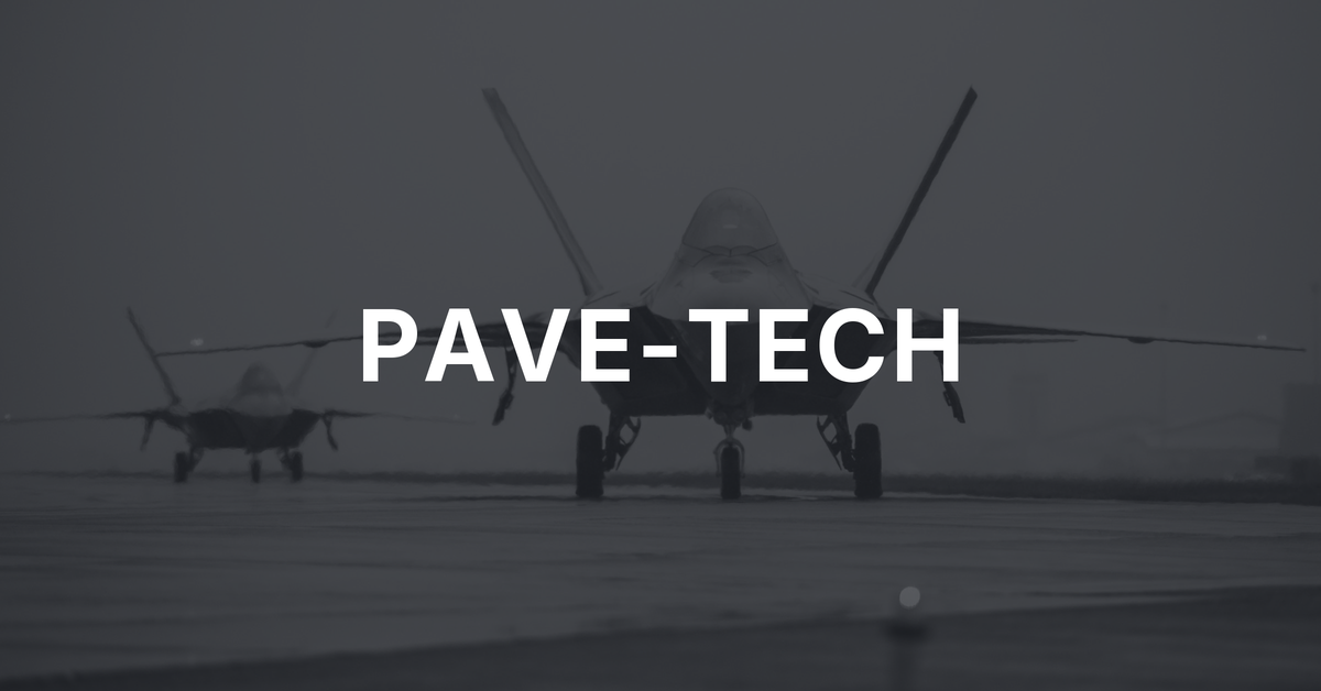 Two F-22 Raptors taxiing on a military runway