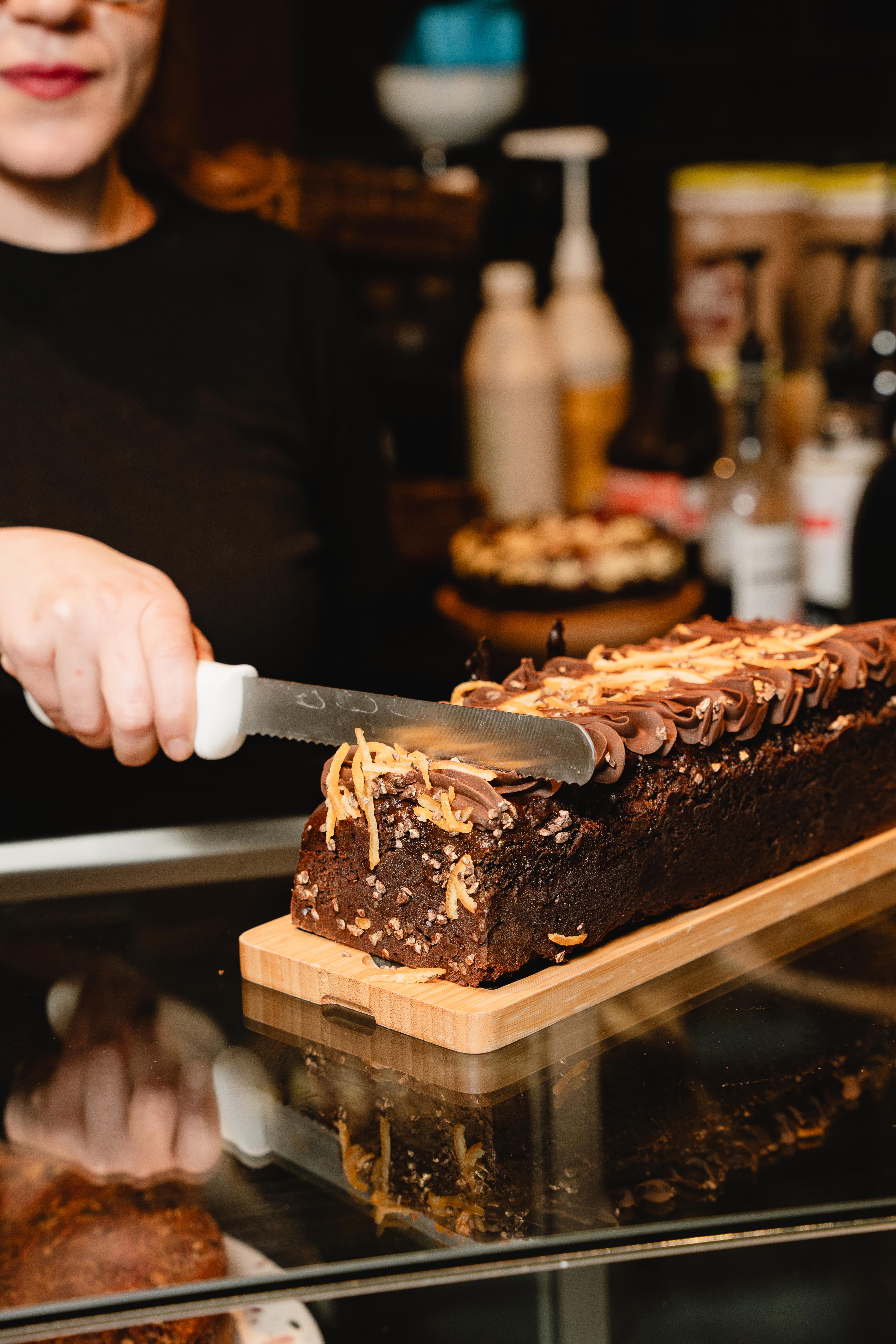 cutting cake in the store at Ovis Coffees