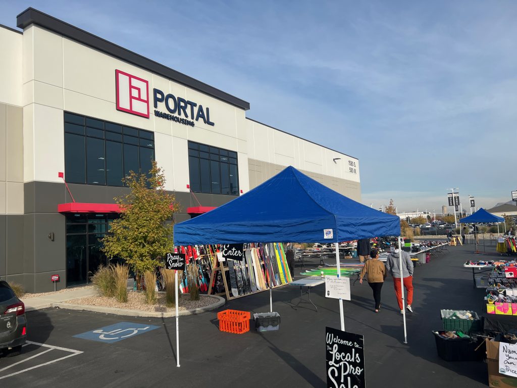 a portal warehouse building with a blue tent in front of it