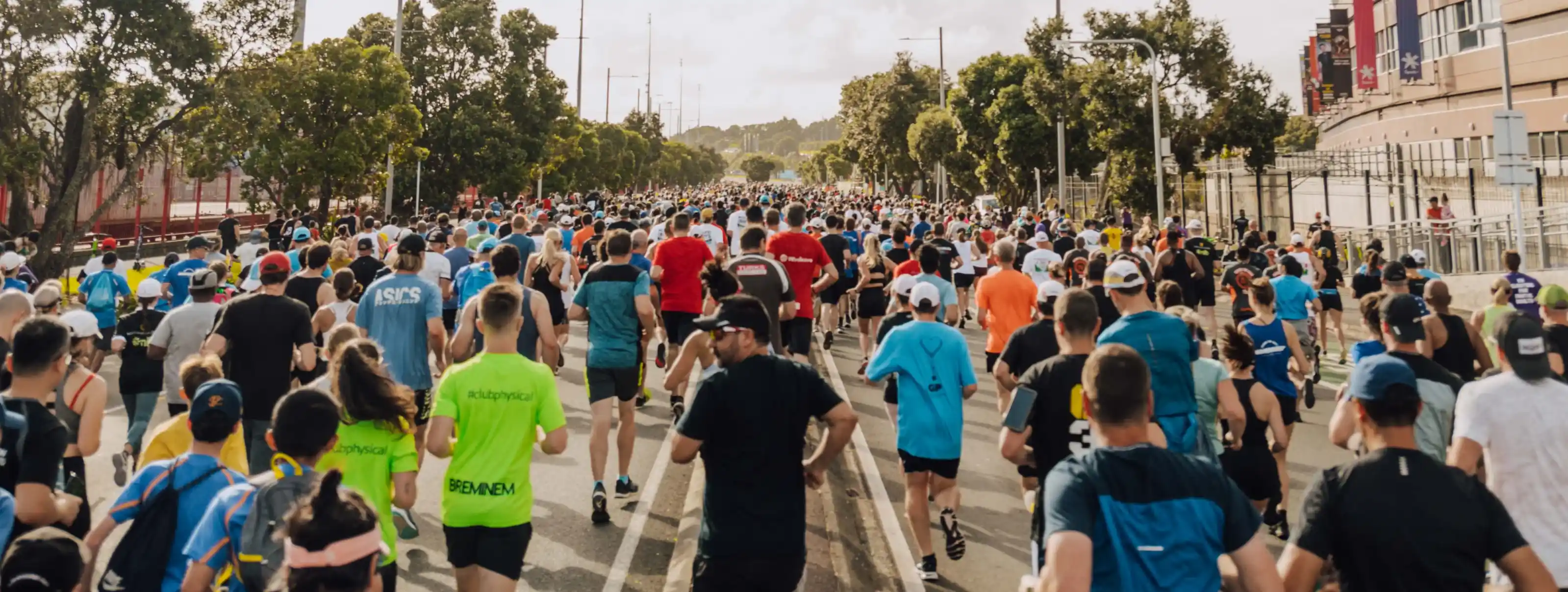 A shot taken behind a large group of runners setting off into the distance