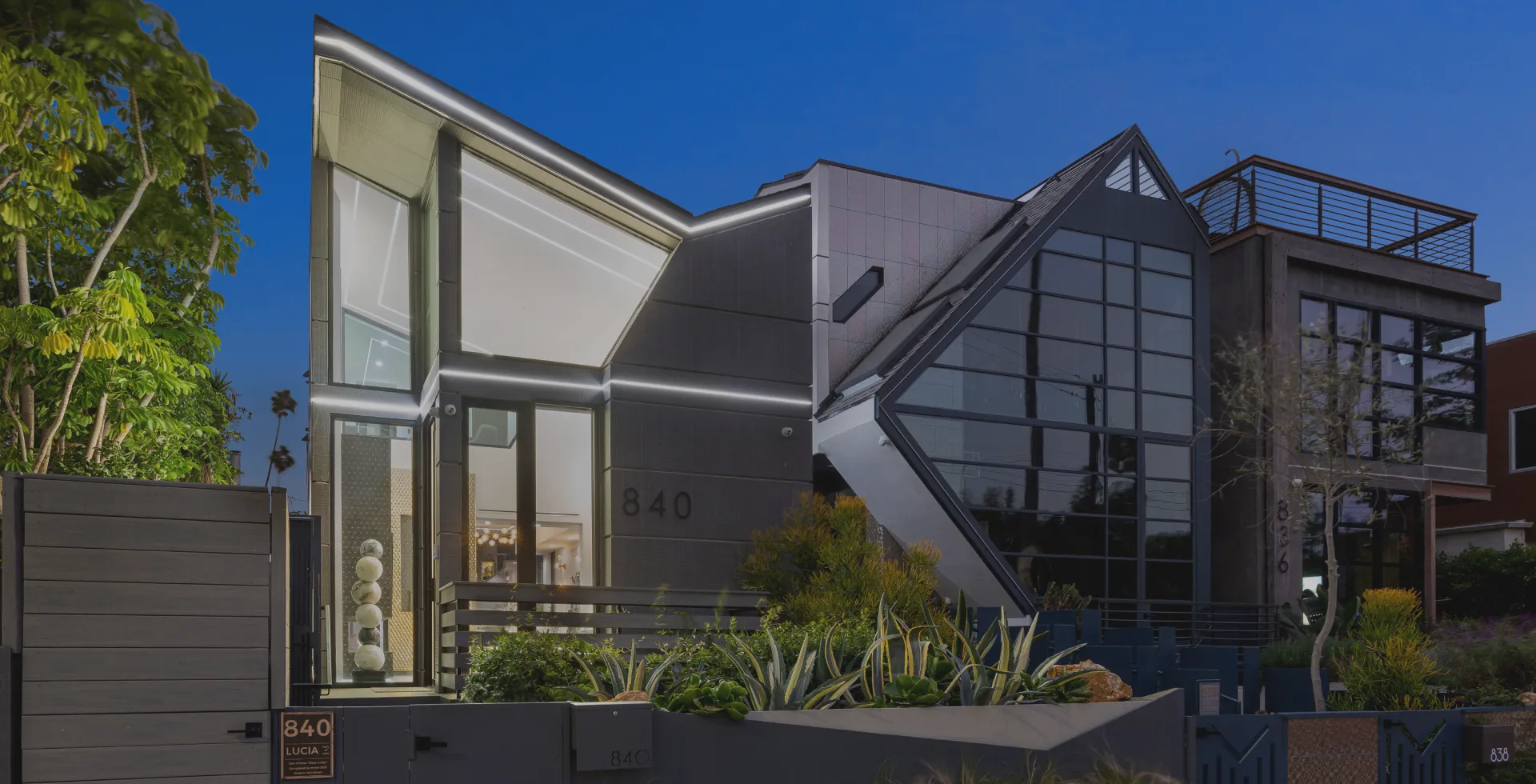 A spacious house with numerous windows and lush greenery in Venice Beach