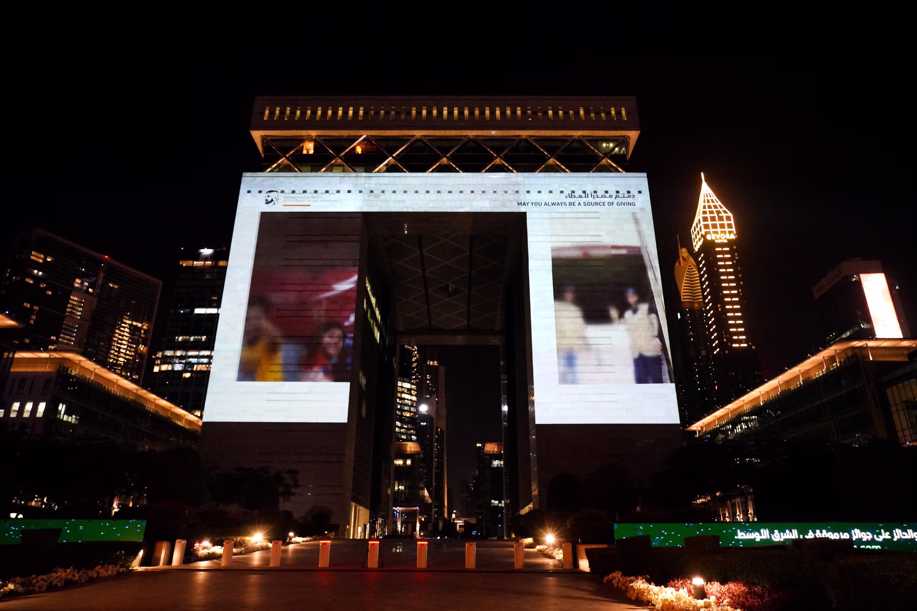 Projection mapping on The Gate at night, One Billion Meals Endowment Campaign DIFC, Dubai, UAE