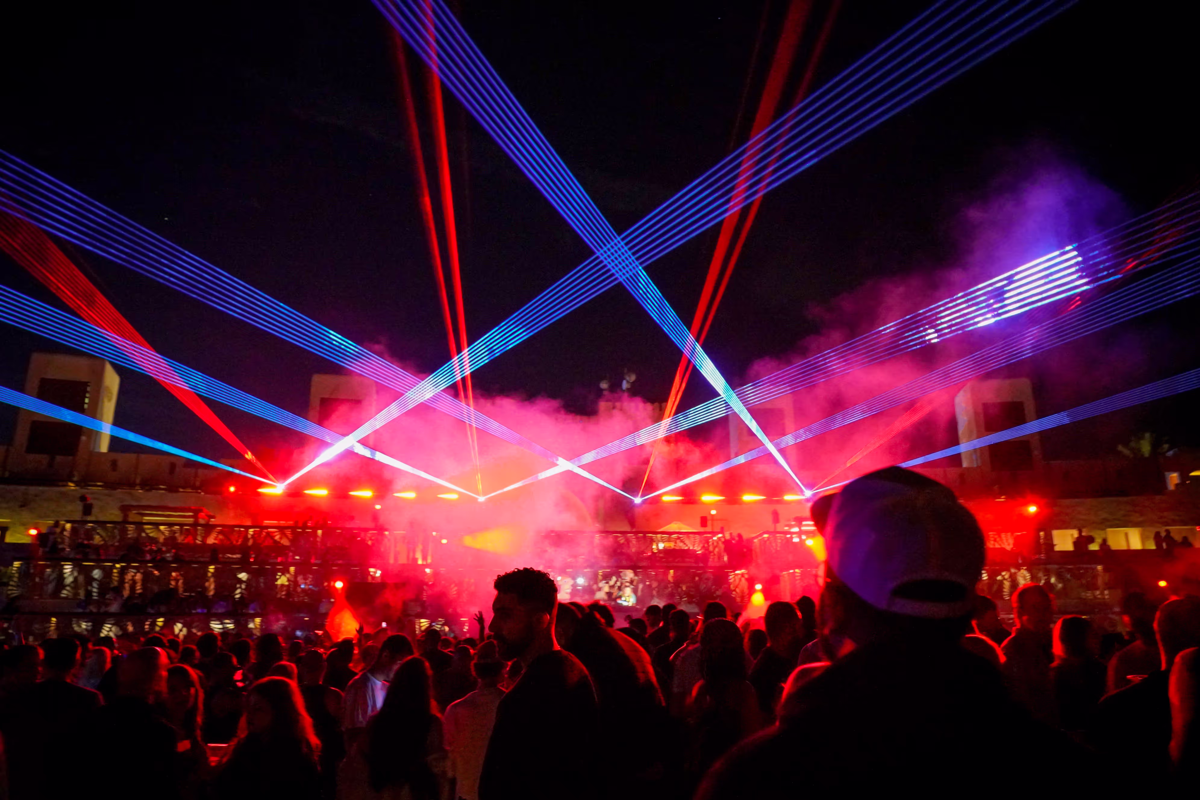 Red and blue lasers through haze over the crowd, Terra Solis Dubai Blondish