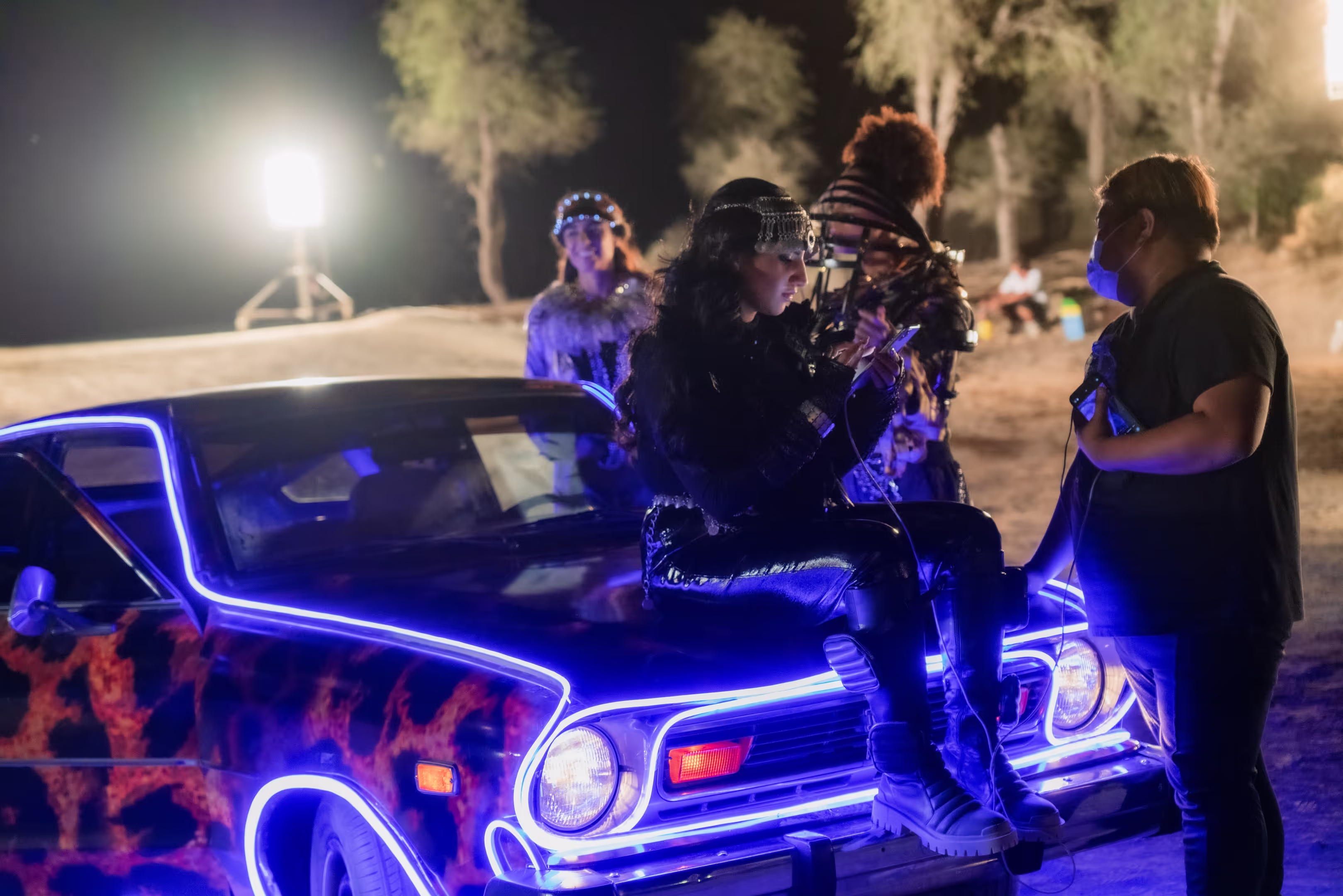 Cast on a neon-lit car during the night shoot, PUBG Noor Stars Video SFX, Dubai, UAE