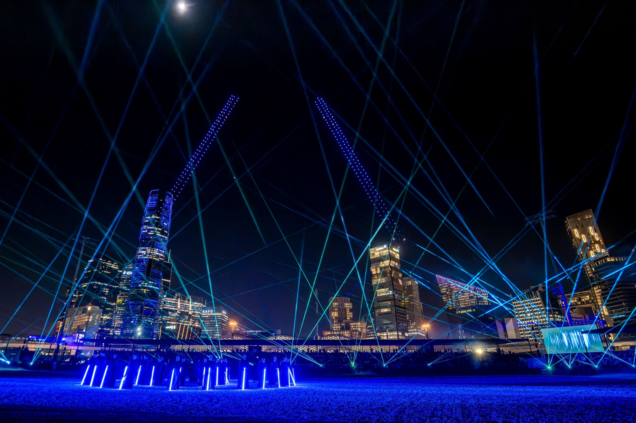 Blue laser beams over the arena and city skyline, Longines Global Champions Tour Finals Riyadh