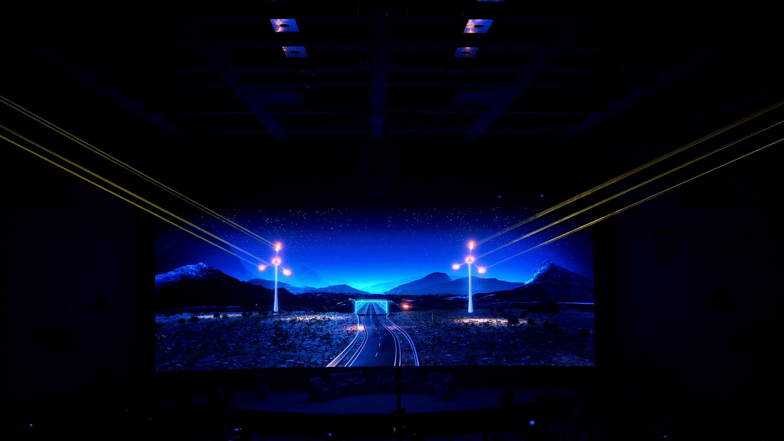 Laser lines over a projected desert road scene, Riyadh Roads Safety Conference