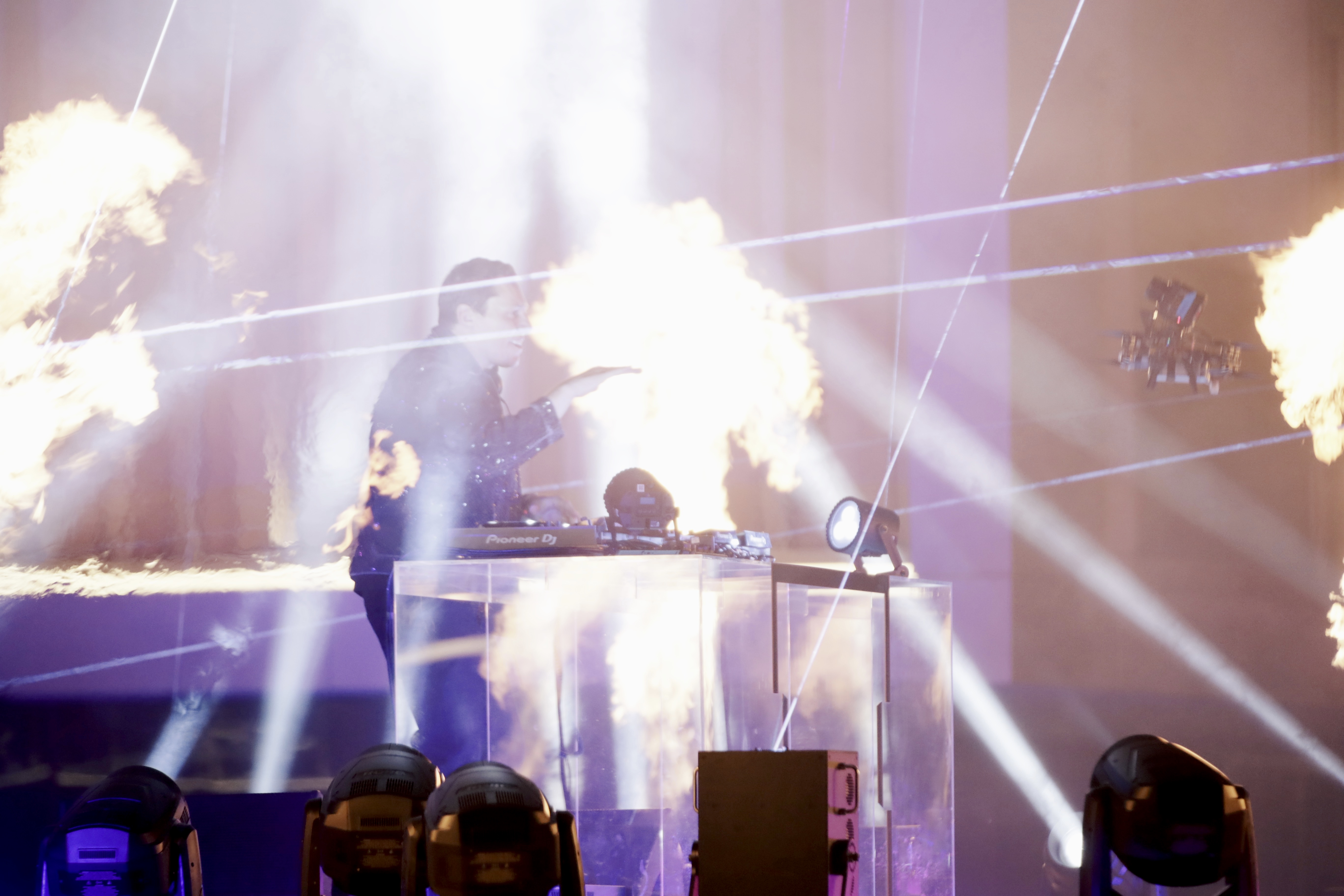 Flame effect and white beams behind the DJ booth, Tiesto & Tate McRae Music Clip Dubai
